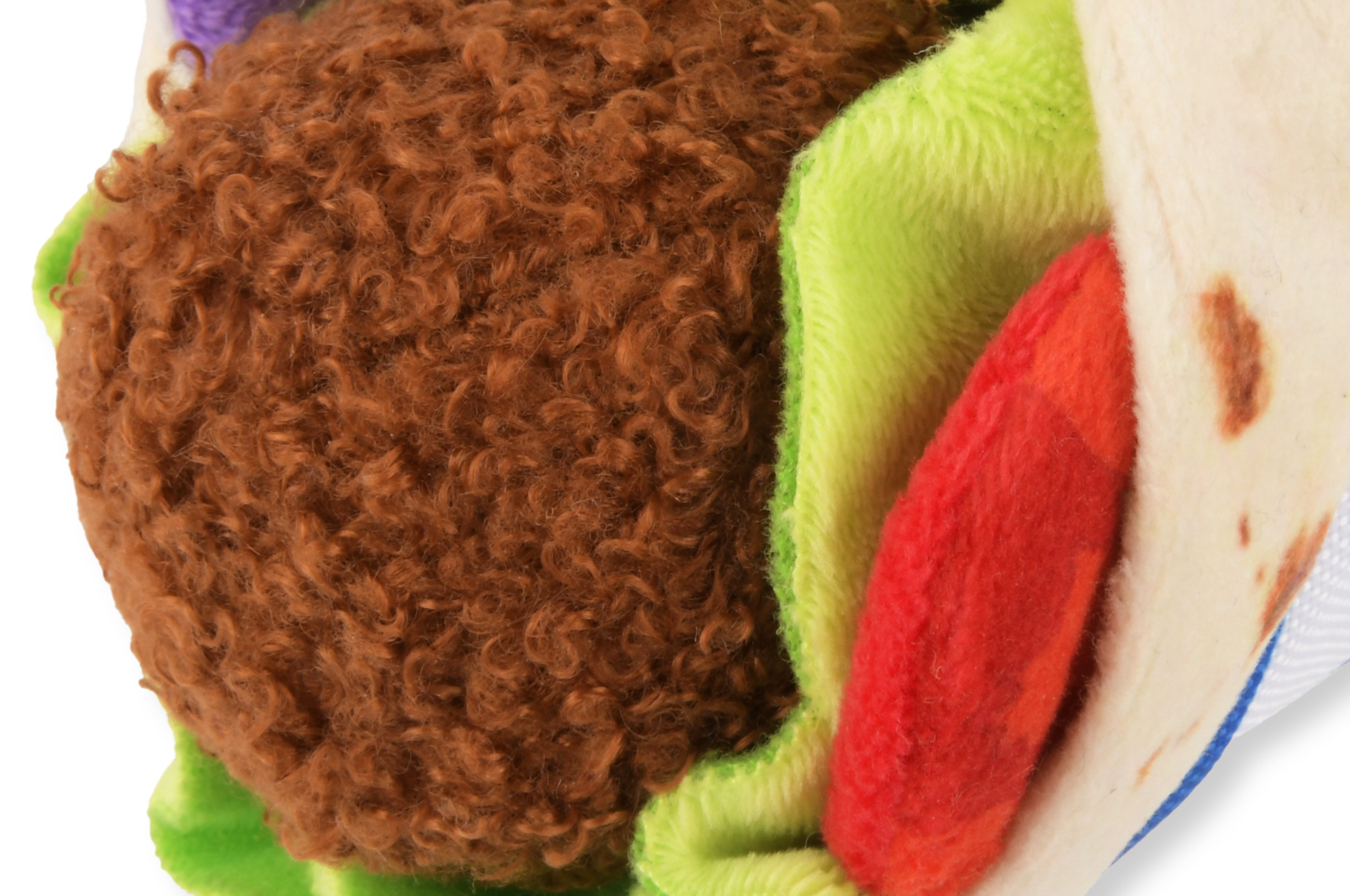 Close up view of a falafel wrap plush squeaky dog toy.